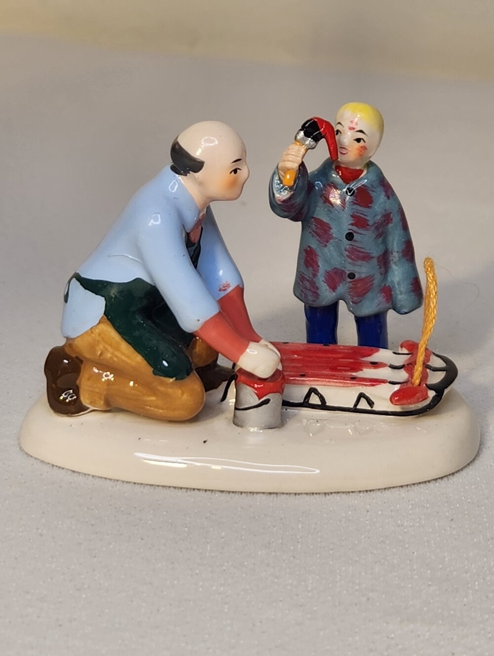 Department 56 Hand-Painted Porcelain Sledding Pair - Red, Blue, Yellow